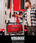 Man organizing tools in garage with 18 Gauge Brad Nailer Pneumatic Nail Gun With Oil-Free Motor hanging on VersaTrack system.