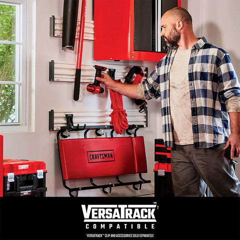Man organizing tools in garage with 18 Gauge Brad Nailer Pneumatic Nail Gun With Oil-Free Motor hanging on VersaTrack system.