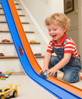 Child playing with 15 Ft Flexible Race Track For Kids 3 Plus Roll Up Portable Starter Set With Strong Suction Cups For One Sixty Four Scale Diecast Cars