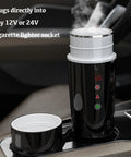 Road Warrior 420ml Portable Water Heater And 12V 24V Travel Kettle in car with steam, plugs into cigarette lighter socket.