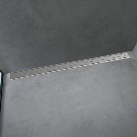 Top Drawer Slick Linear Shower Drain For Standard 30 Inch Rough Opening Featuring Height Adjustable Frame In Brushed Stainless Steel drip free flush mount in a modern bathroom setting.