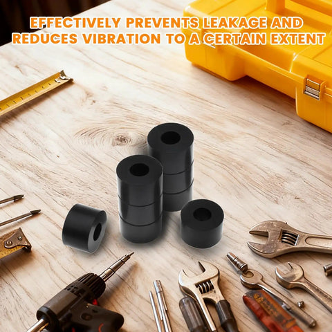 Set Of Eight Built Tough Black Rubber Spacers And Heavy Duty Backing Washers One Inch Outside Diameter With Three Eighths Inner Bore Thick Gasket Rings on a workbench with tools.