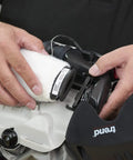Hands replacing dust filter on Badass Powered Air Respirator and Hearing Protection Bundle for woodworking shops.