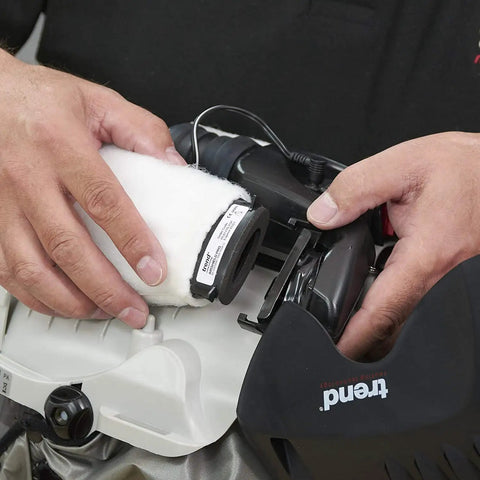 Hands replacing dust filter on Badass Powered Air Respirator and Hearing Protection Bundle for woodworking shops.
