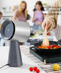 Heavy Duty Solder Fume Extractor Fan With Badass Suction And Slick Design For Desktop DIY Stations beside a cooking scene.