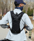 Man wearing a Hydration Backpack With Nylon Reservoir and Reflective Strips in park setting