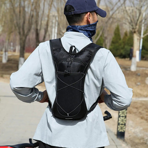 Man wearing a Hydration Backpack With Nylon Reservoir and Reflective Strips in park setting