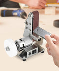 Smooth Operator Mini Belt Sander And Bench Grinder With Variable Speed Dial Forward Reverse Switch And Angled Table For No Sweat Woodworking And Fast Metal Buffing On Any Bench, showcasing sanding belt in use.