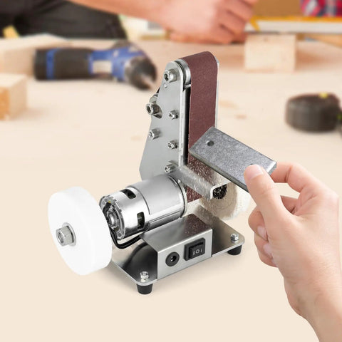 Smooth Operator Mini Belt Sander And Bench Grinder With Variable Speed Dial Forward Reverse Switch And Angled Table For No Sweat Woodworking And Fast Metal Buffing On Any Bench, showcasing sanding belt in use.