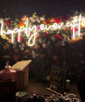 Happily Ever After Neon Sign LED Light for Weddings and Bridal Decor on floral backdrop, warm white glow 80 cm.