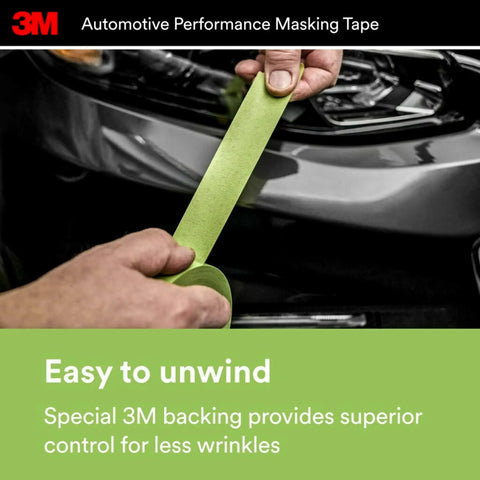 Person unwinding green high-strength automotive masking tape near car, 36mm by 32m, showing conformable backing for easy masking.