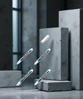 Top Shelf Four Pack Bold White Oil Based Permanent Markers Featuring Slick Quick Dry Ink and Razor Fine Nibs on gray blocks.