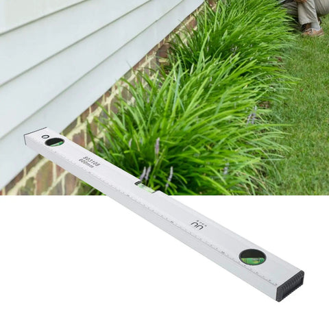 Baxnore Spirit Level Strong Aluminum Alloy with Measurement, (600mm) used outdoors near grass for accurate leveling.