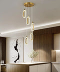 Gold Brushed Modern Pendant Lights for Kitchen Island Three Light LED Dimmable Fixture with Adjustable Height in kitchen setting