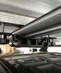 Close-up of the Rooftop Tent Mount Bracket Kit with Quick Release Clamp for roof racks and crossbars for SUVs.