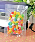 100 Pack Small Vacuum Sealer Bags 2.7x3.9 Inches Open Top Clear Pouches For Food Storage With Tear Notch And Easy Tear, filled with candy