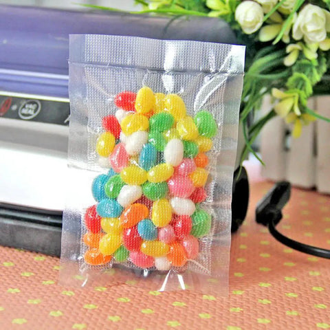 100 Pack Small Vacuum Sealer Bags 2.7x3.9 Inches Open Top Clear Pouches For Food Storage With Tear Notch And Easy Tear, filled with candy