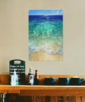 Beach painting on wall above wooden counter with cups and bottles