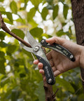 Five In One Garden Pruner Multitool With Folding Scissors And 420 Stainless Steel Blades cutting tree branch outdoors