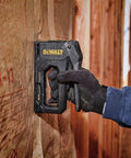Carbon Fiber Body Workhorse 2 In 1 Staple Gun Tacker for Heavy Duty Staples and 18 Gauge Brads in use on insulation wall.