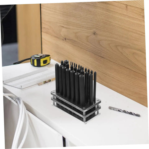 28 Piece Cylindrical Punch Set With Non Slip Base for Woodworking and Maintenance Tools on workshop table