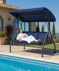 Three Seat Outdoor Porch Swing Glider With Adjustable Canopy Convertible Patio Bed by poolside with thick blue cushions