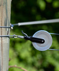Two Pack Nylon Clothesline Pulleys For Outdoor Rope Drying System Smooth Tangle Free Pulley Kit With Durable Nylon And Metal Rollers Easy To Install Perfect For Indoor And Outdoor Clotheslines. White pulley on wooden post with clothesline
