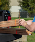 Heavy Duty Reusable Cable Ties With No Sweat Quick Release Lever securely holding wooden boards in a pickup truck bed.