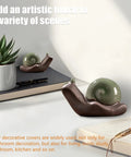 Two Piece Ceramic Snail Toilet Bolt Covers Kicking Up Your Bathroom Vibe With A Super Smooth Push On Install Universal Fit For Worn Floor Bolts And Rusty Plumbing Trim on a desk with plants and notebook.