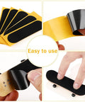 24 Pcs Fingerboard Grip Tape Set Precut 28x100mm Pro Foam Grip Tape for Finger Toys, showing self-adhesive strips on mini skateboards.