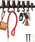 Hella Tough Cast Iron Wall Hook Rack With Seven Cute Cat Designs For Coats Keys And Hats, mounted with keys, bags, and included screws.