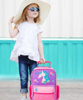 Stephen Joseph kids rolling luggage with unicorn design; purple body and pink accents, wheeled carry-on