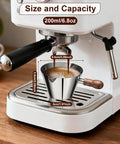 Espresso Shot Cup With Wood Handle, 6.8 Oz Stainless Steel Measuring Cup on espresso machine tray, dual scale shown