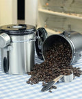 Stainless Steel Airtight Coffee Container Set With Scoop keeps fresh coffee beans on kitchen table, showcasing storage efficiency.