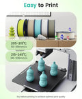 3D printer with Matte PLA Filament 1.75mm Black 1kg printing blue models, spools in background, temperature guidelines displayed.