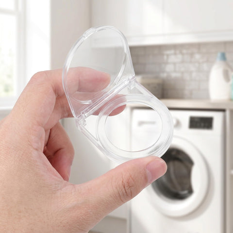 Person holding transparent Industrial Power Button Cover With Adhesive Panel Mount in front of a washing machine.