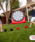 Two adults playing with Inflatable Giant Kick Darts Set With Jumbo Soccer Dartboard And Air Pump For Backyard Carnival Games