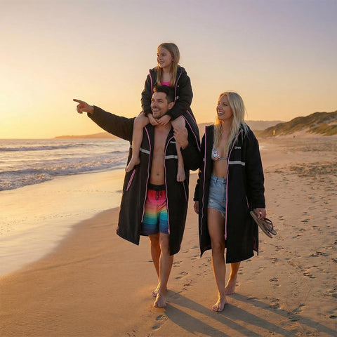 Family wearing Mens Waterproof Swim Parka With Hooded Poncho For Beach Or Pool, Oversized Changing Coat, walking on beach at sunset