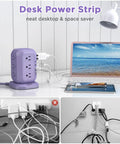 Purple 16 In 1 Power Strip Tower With 12 AC Outlets And 4 USB Ports 10 Ft Extension Cord on desk with laptop and lamp