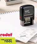 Six Digit Self Inking Numbering Stamp With Crisp Black Ink Marks And Zero Mess Build For Fast Office Workflows That Really Nails The Job Every Single Time on a ledger with receipts.