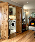 Double 38 By 84 Inches Unfinished Alder Wood Bifold Barn Doors With Low Clearance Box Rail Sliding Hardware Set installed in living room