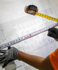 9235 Heavy Duty Magnetic Tape Measure With 16 Foot Reach, Double Hook, Double Sided Nylon Reinforced Blade in use on blueprint