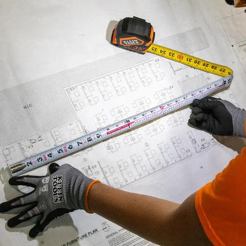9235 Heavy Duty Magnetic Tape Measure With 16 Foot Reach, Double Hook, Double Sided Nylon Reinforced Blade in use on blueprint