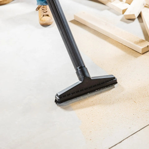 All Purpose Wet Dry Vac Attachment Kit For Home And Shop Use with floor brush in use on sawdust-covered floor