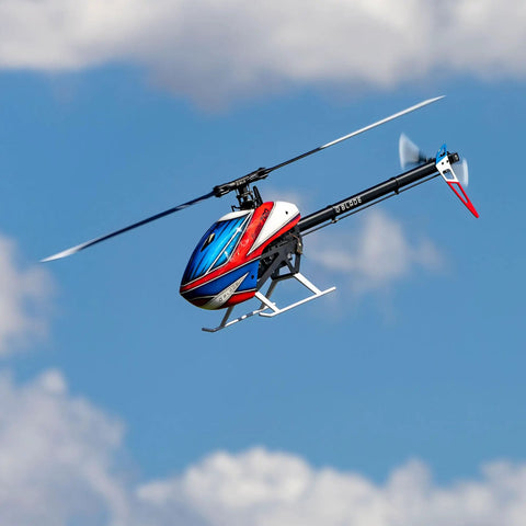 Fusion 700 Kit High Performance Super Combo With Carbon Fiber 700mm Main Rotor And 105mm Tail Blades, blue sky background.