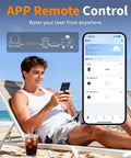 Man on beach using phone app to control Brass WiFi Sprinkler Timer For Garden Hose 2 Zone Smart Water Timer