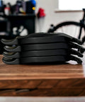 Interlocking Four-Piece Tire Lever Set For Road, MTB, Gravel And BMX Bikes on wooden table, side view, black color