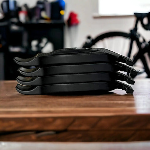 Interlocking Four-Piece Tire Lever Set For Road, MTB, Gravel And BMX Bikes on wooden table, side view, black color