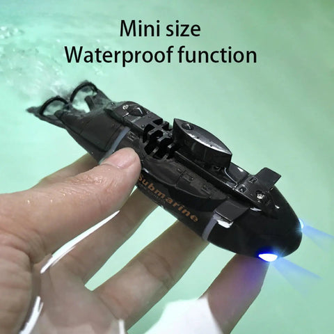Mini RC Submarine For Kids With 6CH Remote Control, Totally Cool High Speed Waterproof Diving Toy For Pools, Lakes, And Bathtubs, Easy To Control With 2.4GHz Wireless Tech And Front Navigation Lights, Ideal Gift For Boys And Girls Black held in a hand above water.