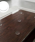 16 Pack Non Adhesive Rubber Feet for Glass Tables and Counters Transparent No Slip Cushions on wooden table close-up
